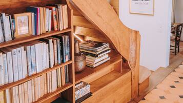 A wooden staircase with bookshelves on either side, leading to an upper level.