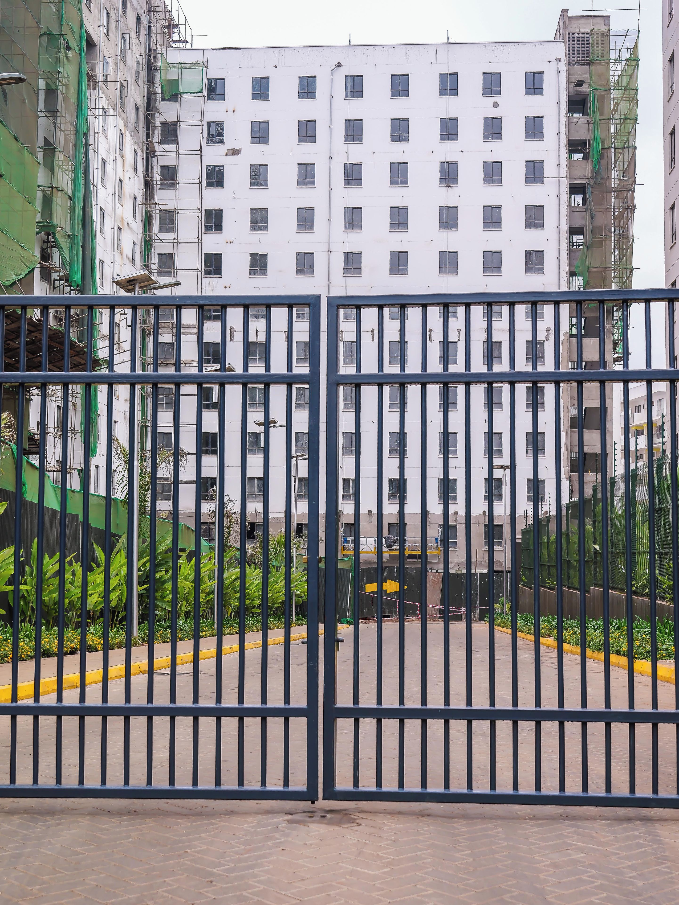 A gated entrance with a building in the background.
