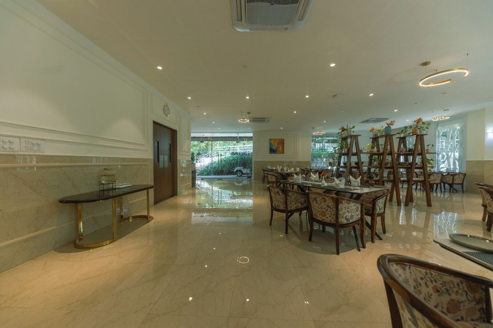 A spacious dining area with a long table, chairs, and a buffet setup.