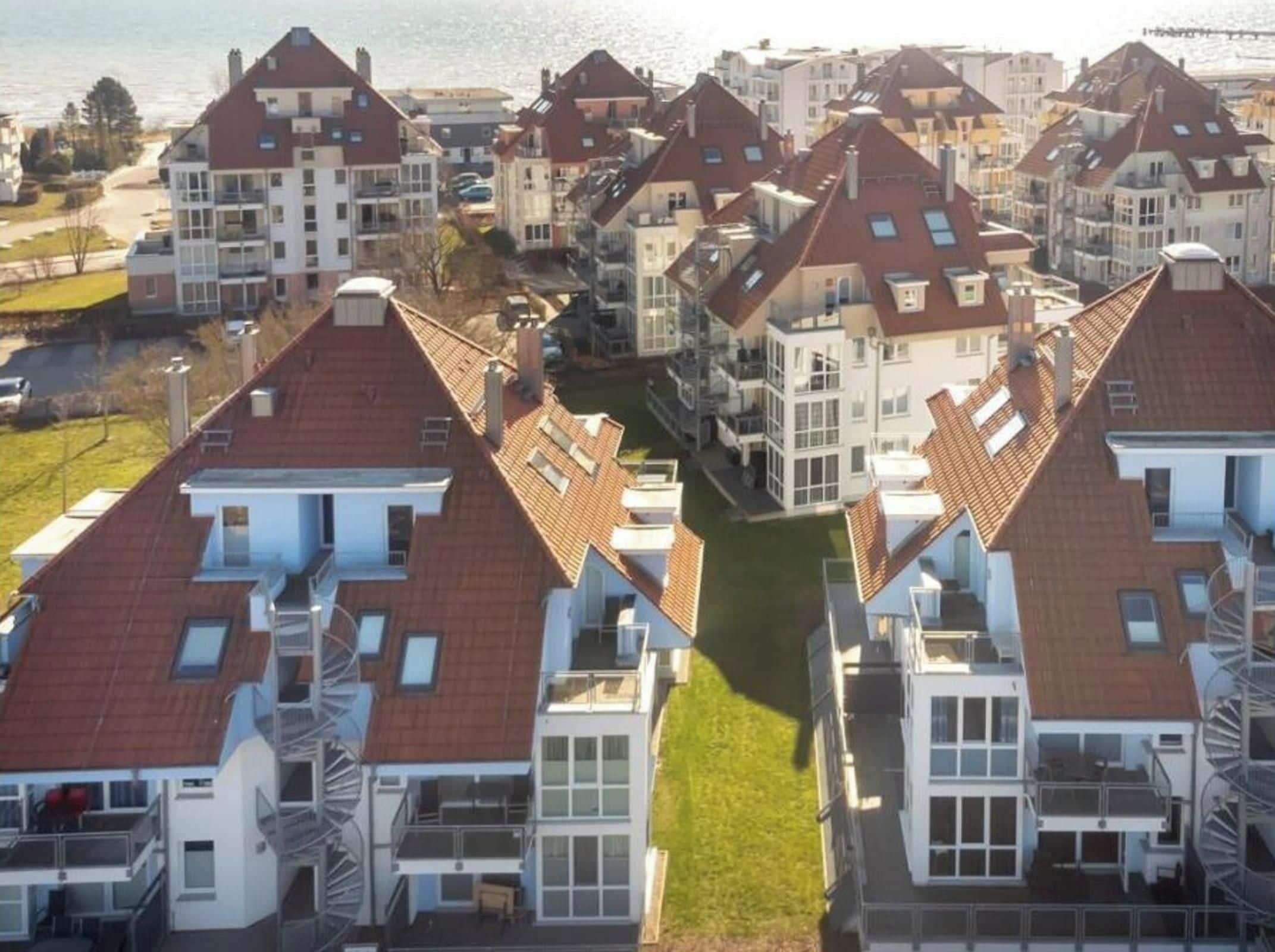 A residential area with multiple houses featuring pitched roofs and balconies.