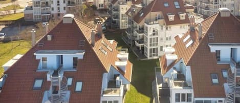 A residential area with multiple houses featuring pitched roofs and balconies.