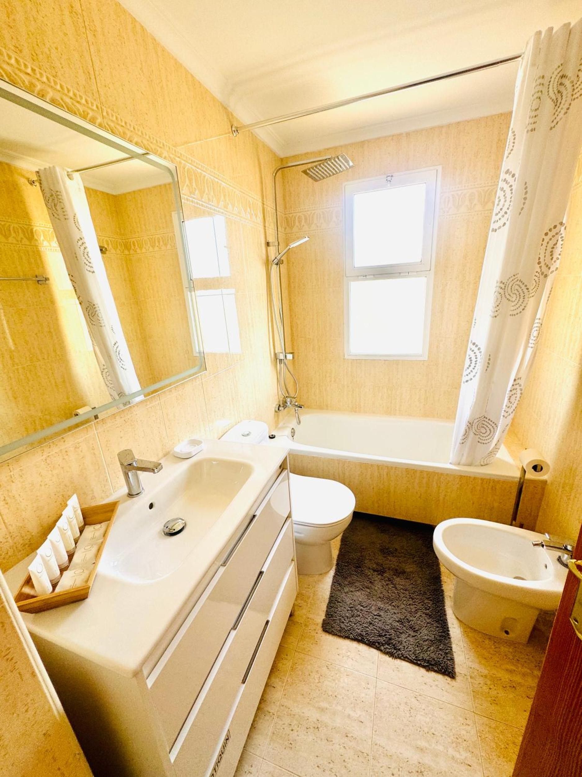 A bathroom with a bathtub, a toilet, a sink, and a shower.