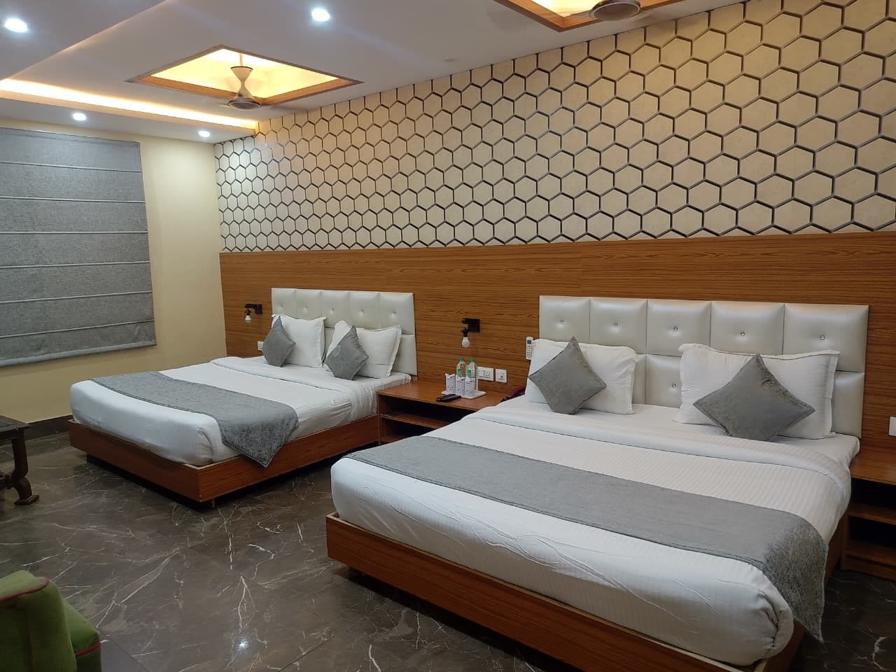 A hotel room with two beds, a wooden headboard, a wall with a honeycomb pattern, and a marble floor.