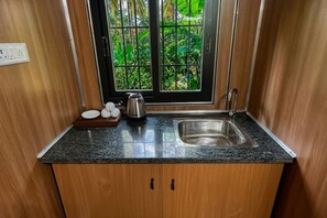 A kitchen with a window, a sink, and a countertop.