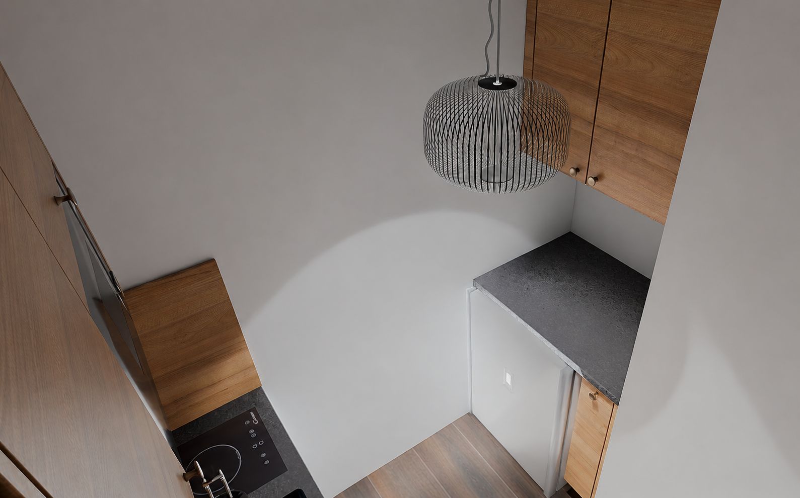 A compact kitchen with a modern design, featuring a built-in oven, a small refrigerator, and a unique hanging light fixture.