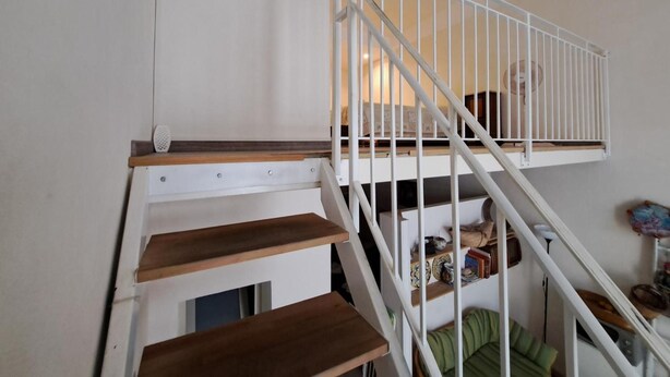 A staircase with white railings and wooden steps leading to a landing. - "Ground Floor" Apartment with Wi-Fi, Air Conditioning, and Step-Free Access (Scicli)