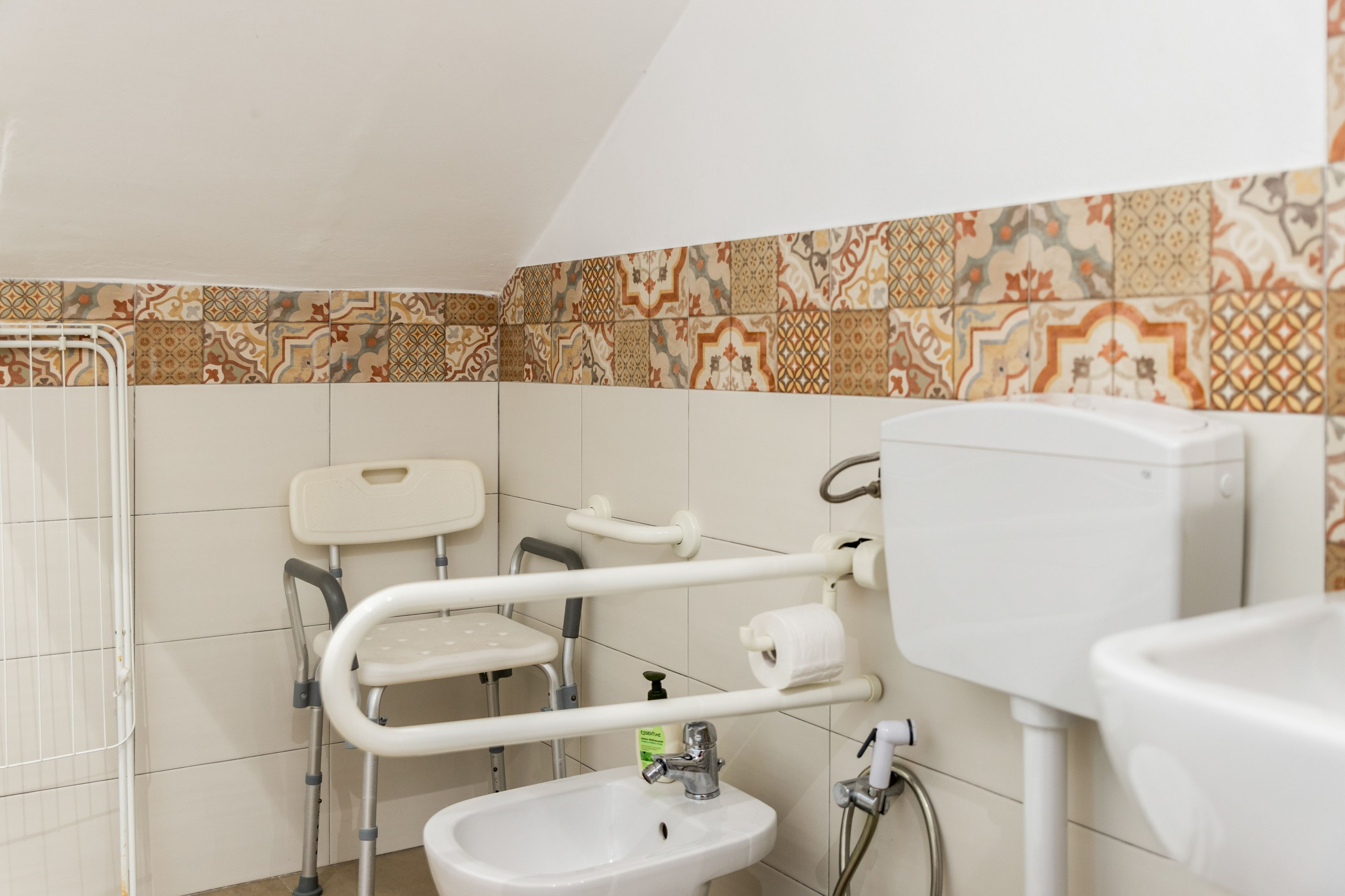 A bathroom with a white sink, a toilet, and a shower area.