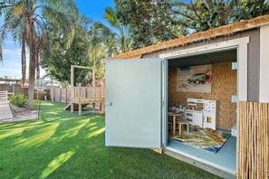A small, enclosed play area with a slide and a table with toys. - Blue Palm Beach Retreat (Bradenton)