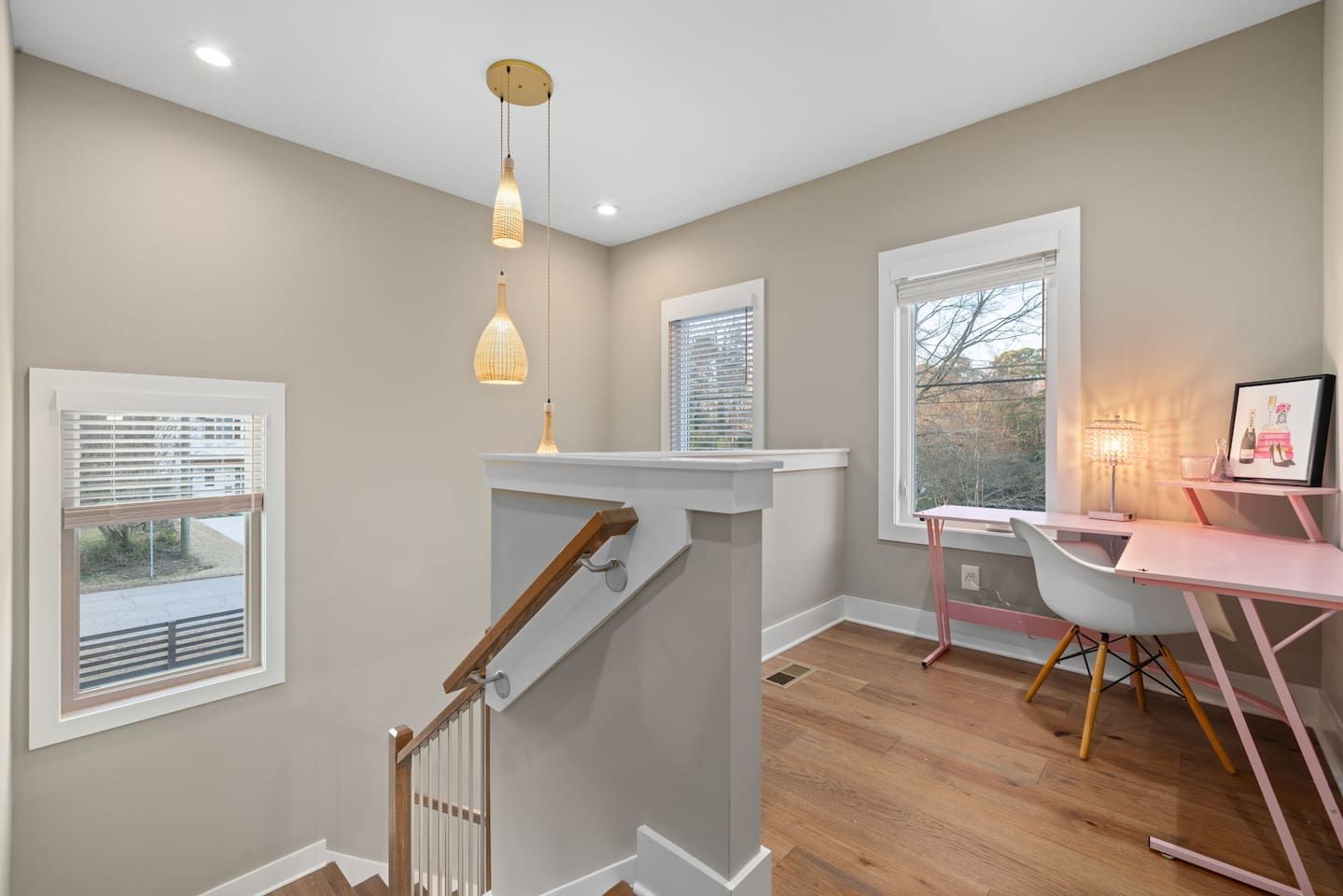 A modern interior with a staircase, a desk, and a chair.