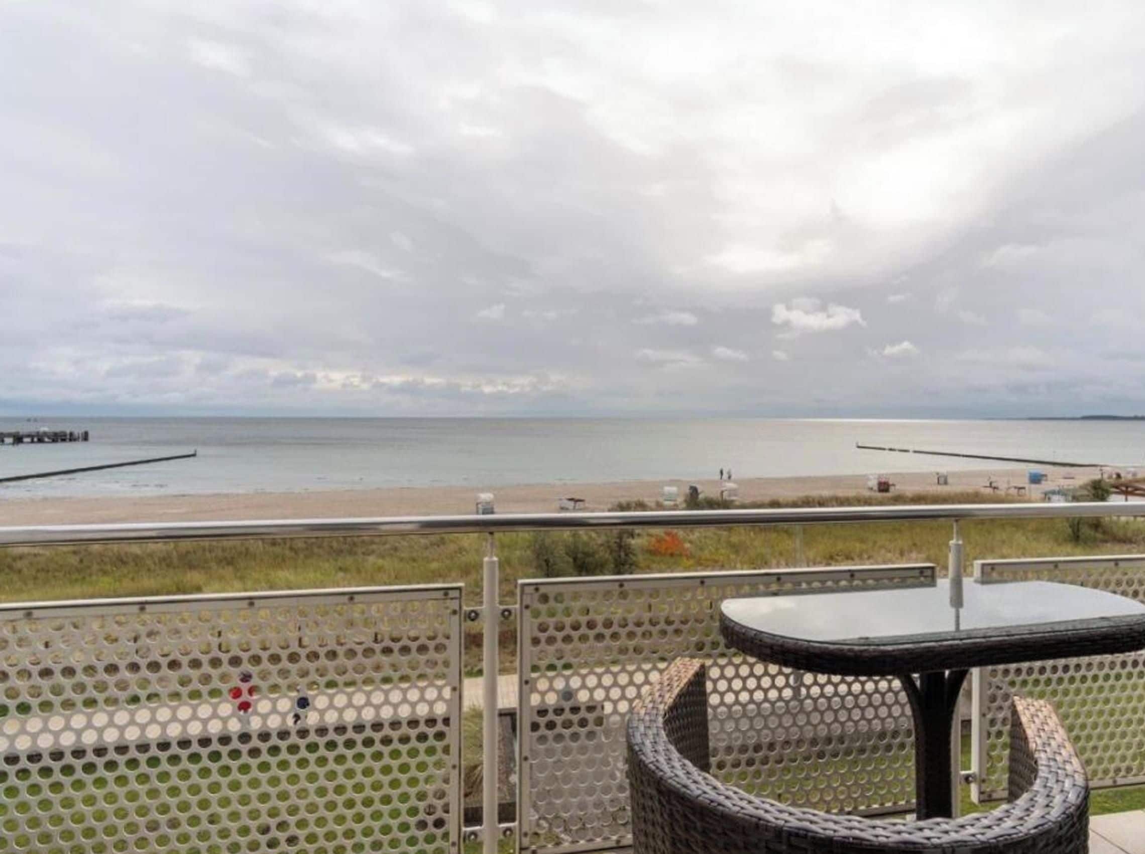Un balcon avec vue sur la plage et la mer.