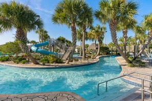 A swimming pool with a water slide, surrounded by palm trees and a thatched-roof structure. - Upstay Family Home w Pool Cinema Championsgate (Davenport)