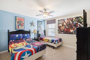 A bedroom with two beds, a ceiling fan, and superhero-themed bedding. - Upstay Family Home w Pool Cinema Championsgate (Davenport)