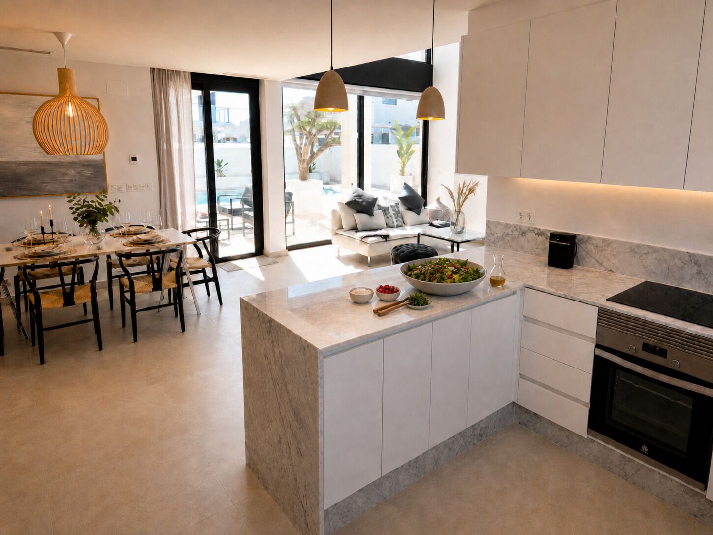 A modern kitchen with a central island, built-in oven, and a dining area with a table set for four.
