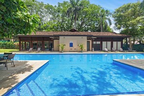 A swimming pool with lounge chairs and a building with a tiled roof. - Hermosa del Mar 1-6B | Ocean Views, Walk to Beach (Playa Hermosa)