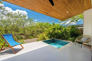 A pool area with a clear view of the sky, surrounded by lush greenery and a wooden pergola. - Tamarindo Compound w/ Pools & Stunning Views (Tamarindo)