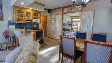 A compact living space with a kitchenette, dining area, and seating.