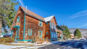 A wooden house with a balcony, a chimney, and a clear sky. - Large Ski Home: Seasonal Pool & Year-round Hot Tub (Ellicottville)