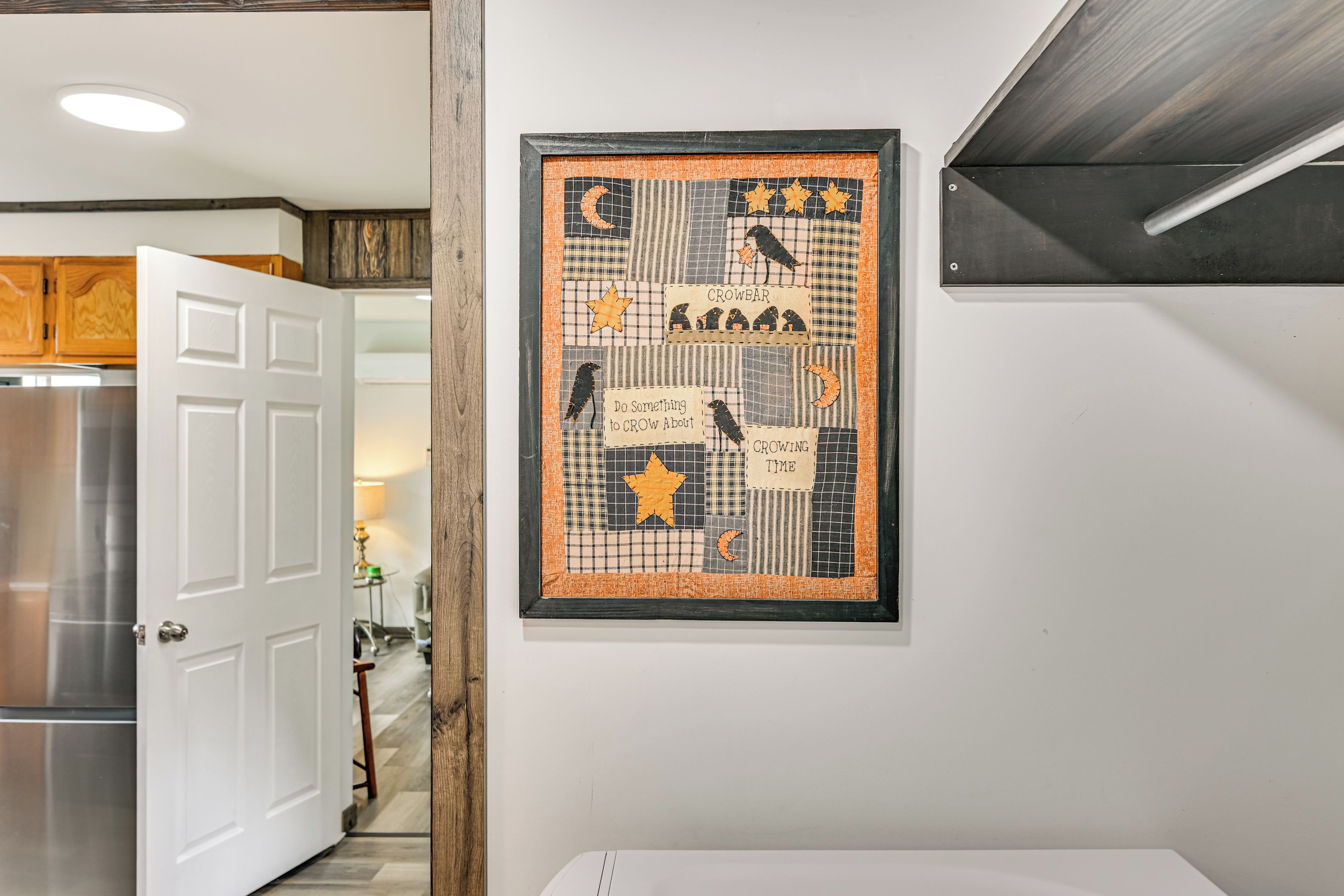 A framed artwork with a bird theme on a wall.