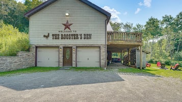 A building with a sign reading 'Welcome to The Rooster's Den' and a star emblem above the sign.