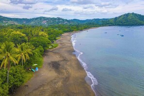 A beach with a clear view of the ocean and a forested hillside in the background. - 3-unit Bundle: Club Voca Pool Access, Near Beach! (Sardinal)