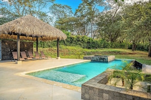 A pool area with lounge chairs, a thatched-roof structure, and a hot tub. - Walk to 2 Beaches! Villa w/ Pool, Lava-stone Spa (Cabo Velas)