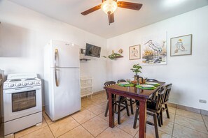 A compact kitchen with a refrigerator, stove, and ceiling fan. - 1 Mi to Beach: Playas del Coco Condo w/ Pool (Sardinal)