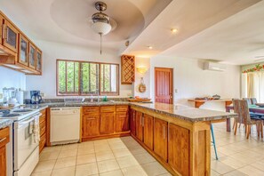 A spacious kitchen with wooden cabinets, a built-in dishwasher, and a large island. - Ocean Views: Bahia Pez Vela Resort Condo (Sardinal)