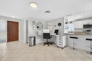 A modern kitchen with white cabinets, a stainless steel oven, and a microwave. - Pet-friendly Condo Near the Beach w/ Boat Slip (Treasure Island)
