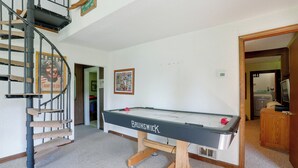 A pool table with a wooden base and a sign, a spiral staircase, and a framed picture on the wall. - Carley House Too: Pet Friendly, Hot Tub, Fire Pit! (Ellicottville)