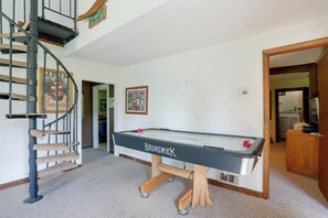 A pool table with a wooden base and a sign, a spiral staircase, and a framed picture on the wall. - Carley House Too: Pet Friendly, Hot Tub, Fire Pit! (Ellicottville)