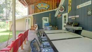 A covered outdoor area with a long table, chairs, and a grill. - Carley House Too: Pet Friendly, Hot Tub, Fire Pit! (Ellicottville)