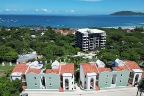 A coastal hotel with multiple buildings, including a prominent multi-story structure with balconies. - Walk to the Beach & Town! Tamarindo Condo (Tamarindo)