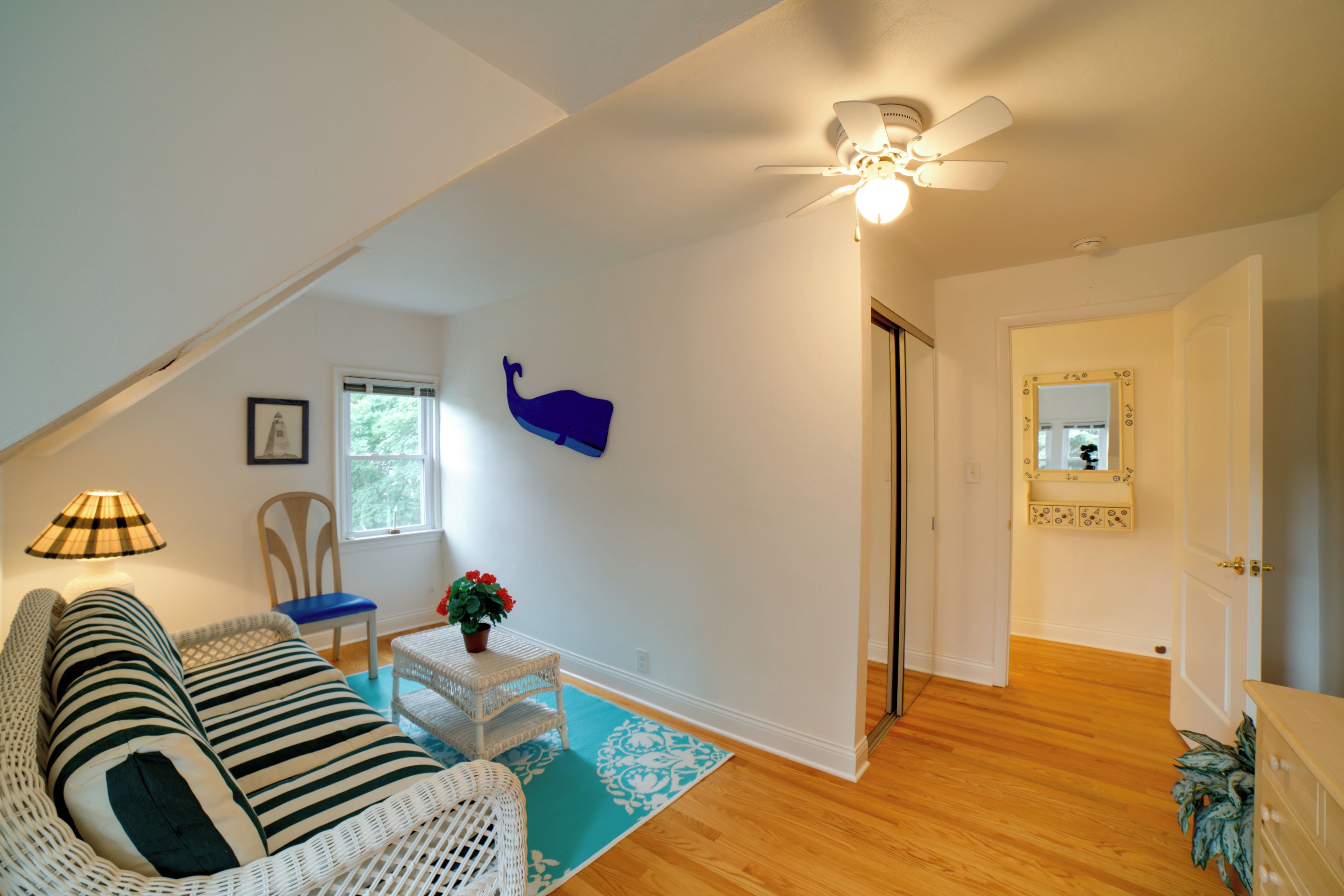 A living room with a sofa, chair, and a decorative wall piece.
