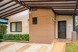 A building with a brown facade, a dark door, and a window.