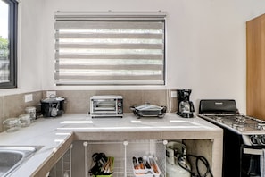 A modern kitchen with a built-in oven, a coffee maker, and a toaster.