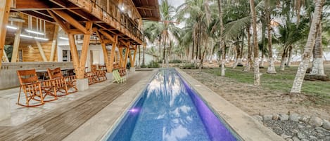 A poolside area with wooden deck seating and a pool.