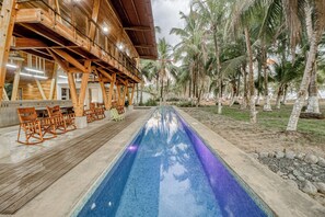 A poolside area with wooden deck seating and a pool.