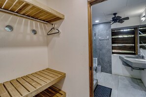 A bathroom with a wooden bench, a ceiling fan, and a modern sink. - Award-winning Oceanfront Home w/ Pool & Hot Tub! (Bejuco)
