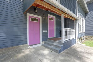 A two-story house with a front porch, a pink door, and a mailbox. - Downtown Spacious 5BR w/ Game Room (Ellicottville)