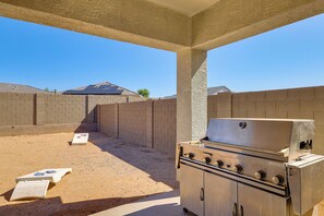 An outdoor barbecue area with a grill and a game table. - Yard, Patio & Spacious Interior! Casa Grande Home (Casa Grande)