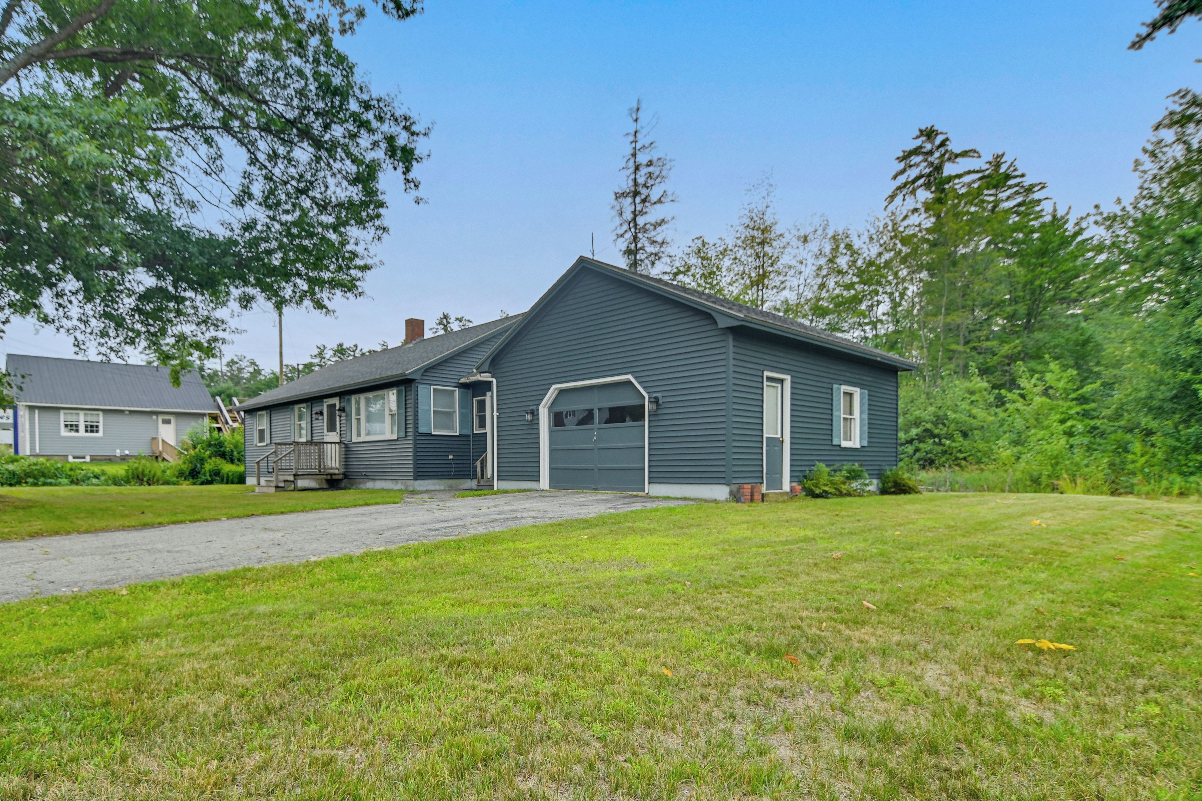 A single-story house with a front garage, a covered porch, and a well-maintained lawn.