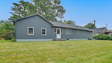 A single-story house with a front porch, a garage, and a small yard.