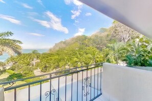 A balcony with a view of a coastal landscape, including trees and the sea. - Bahia Pez Vela Resort: Condo w/ Beach Access! (Sardinal)