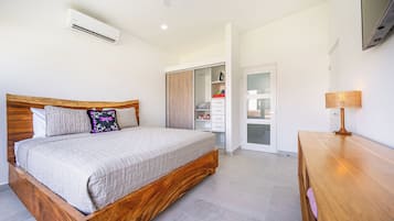 A bedroom with a wooden bed, a wardrobe, and a bedside table.