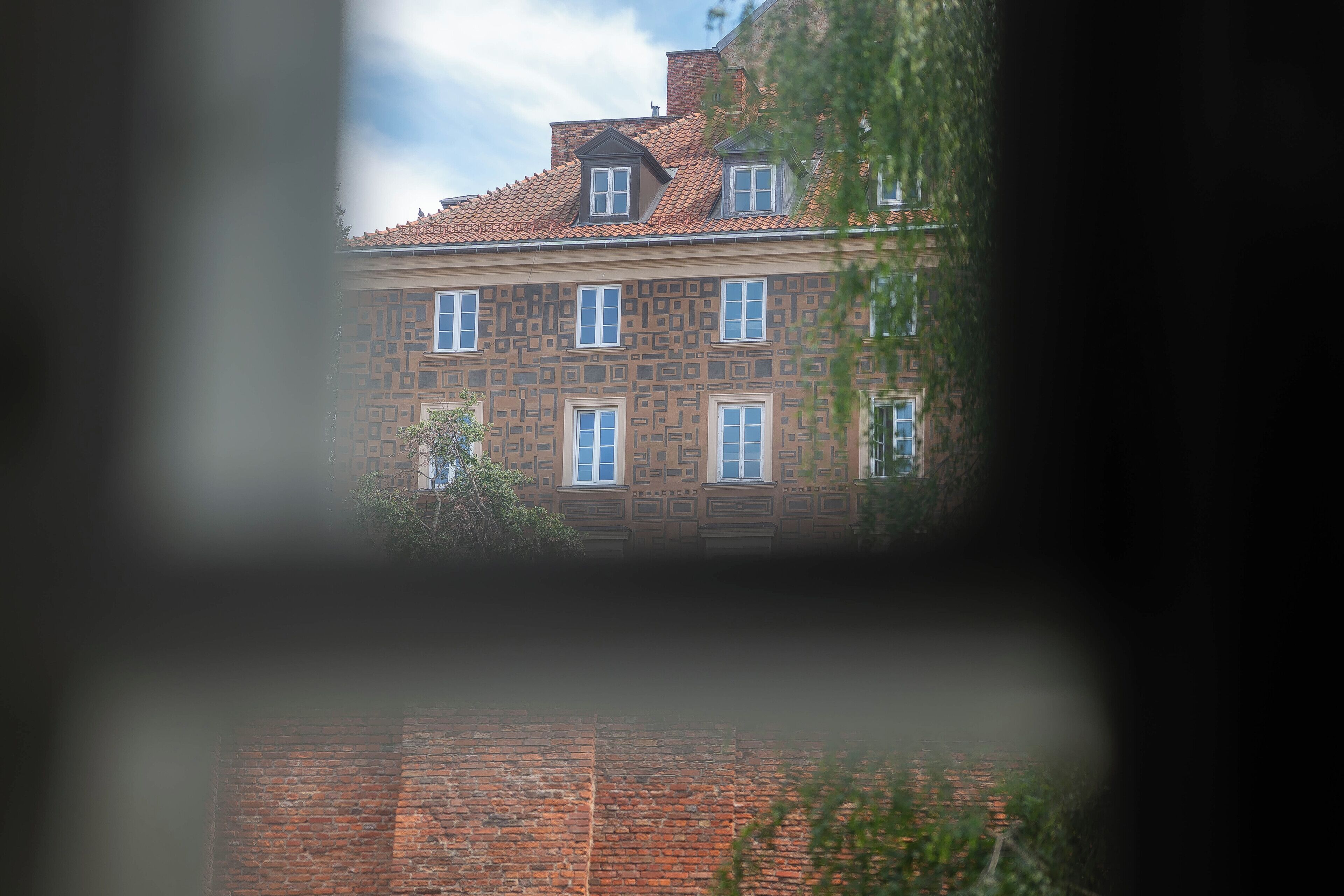 A building with a patterned facade and multiple windows.