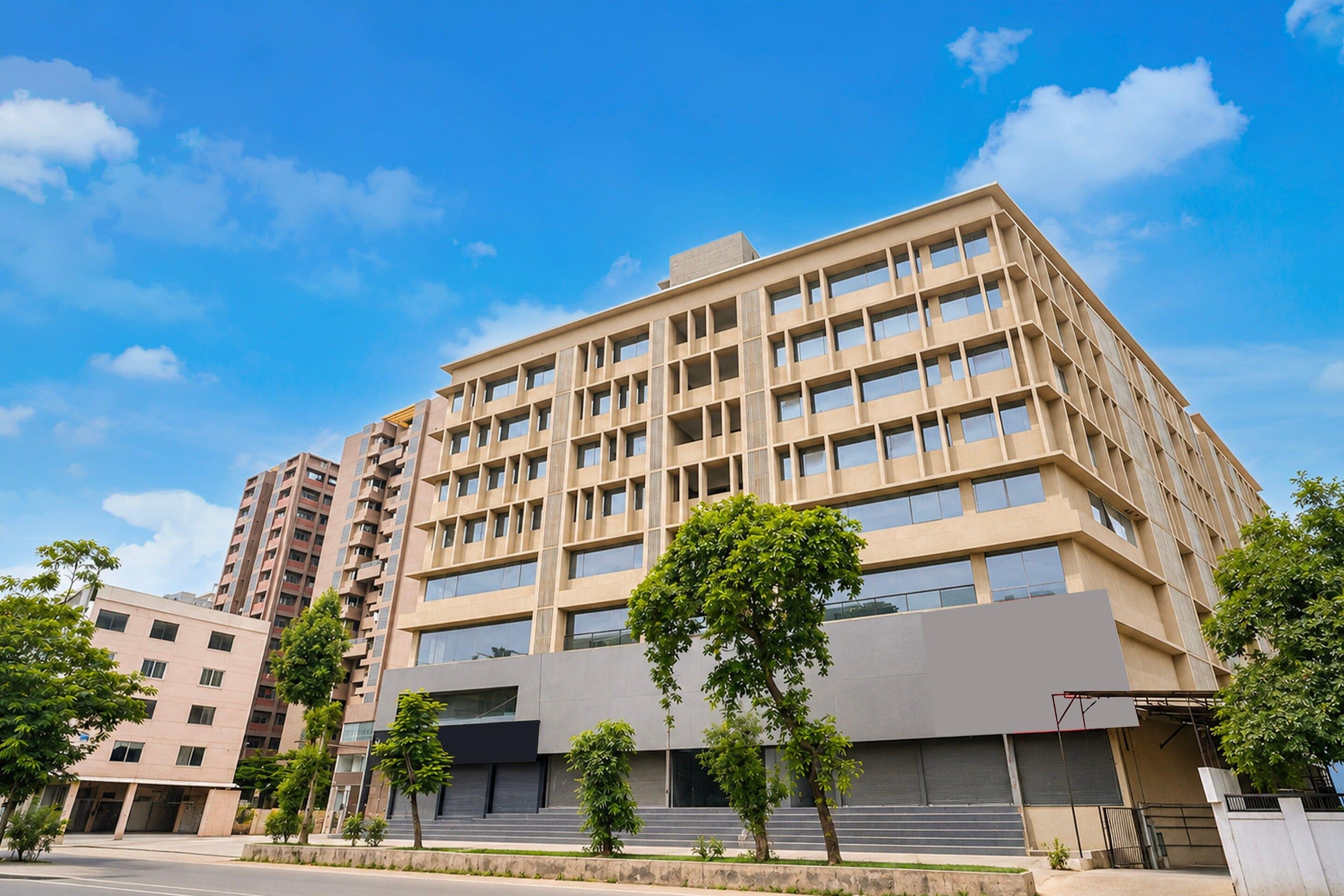 A multi-story building with a modern architectural design, featuring a flat roof and a series of balconies.