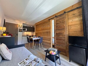 A compact living space with a kitchenette, a dining area, and a seating area with a sofa and a coffee table. - Functional apartment near slopes - 4 guests (Vars)