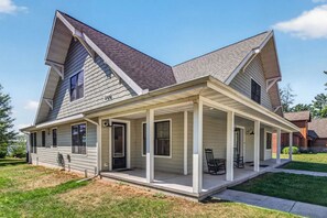 A two-story house with a covered porch and a front door. - Driftwood Daydream  Dog-friendly, lakefront house with beach access, dock, AC (St.Germain)