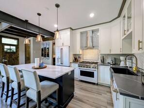 A modern kitchen with a central island, stainless steel appliances, and pendant lighting. - NEW | Updated | Forest Views | Free Shuttle (Keystone)