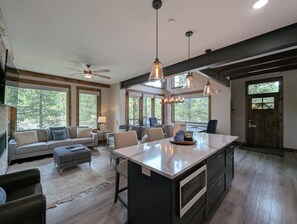 A spacious kitchen with a large island, pendant lighting, and a ceiling fan. - NEW | Updated | Forest Views | Free Shuttle (Keystone)